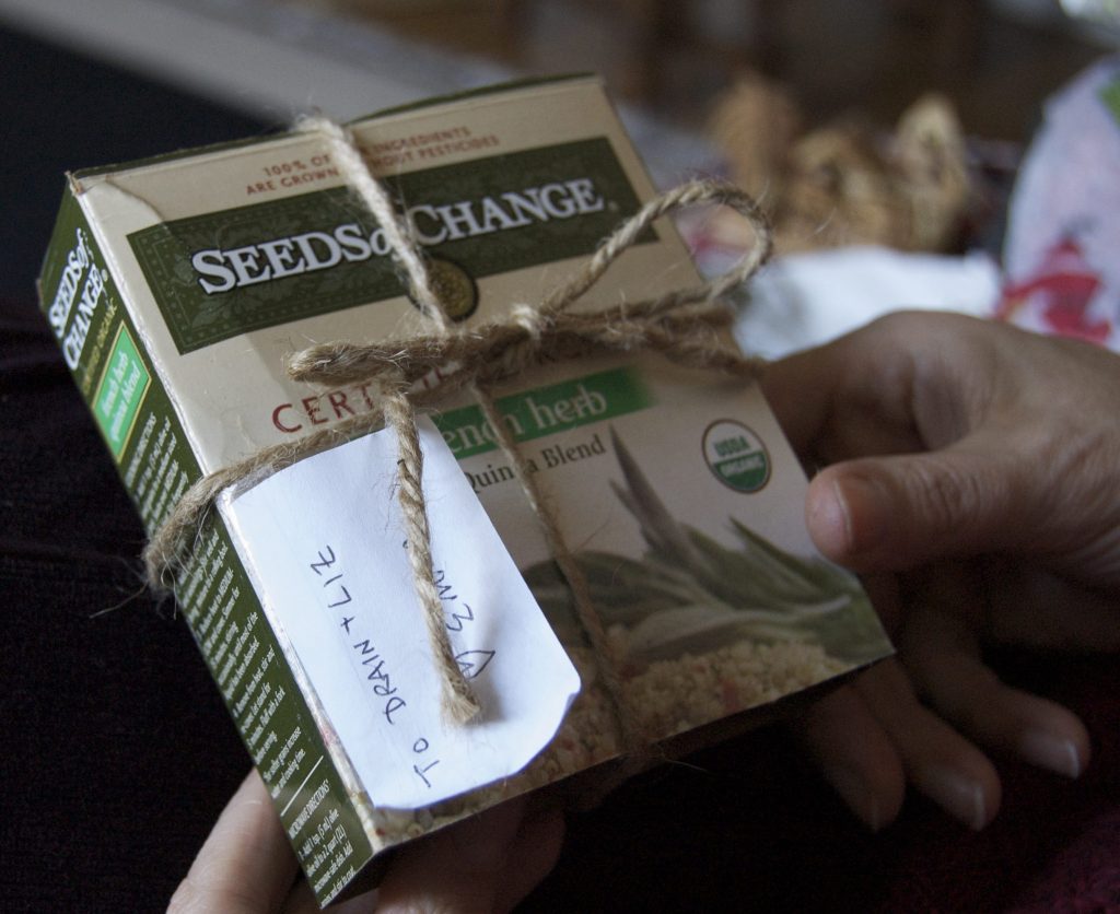 A pack of "Seeds of Change" quinoa and herb blend, wrapped in twine